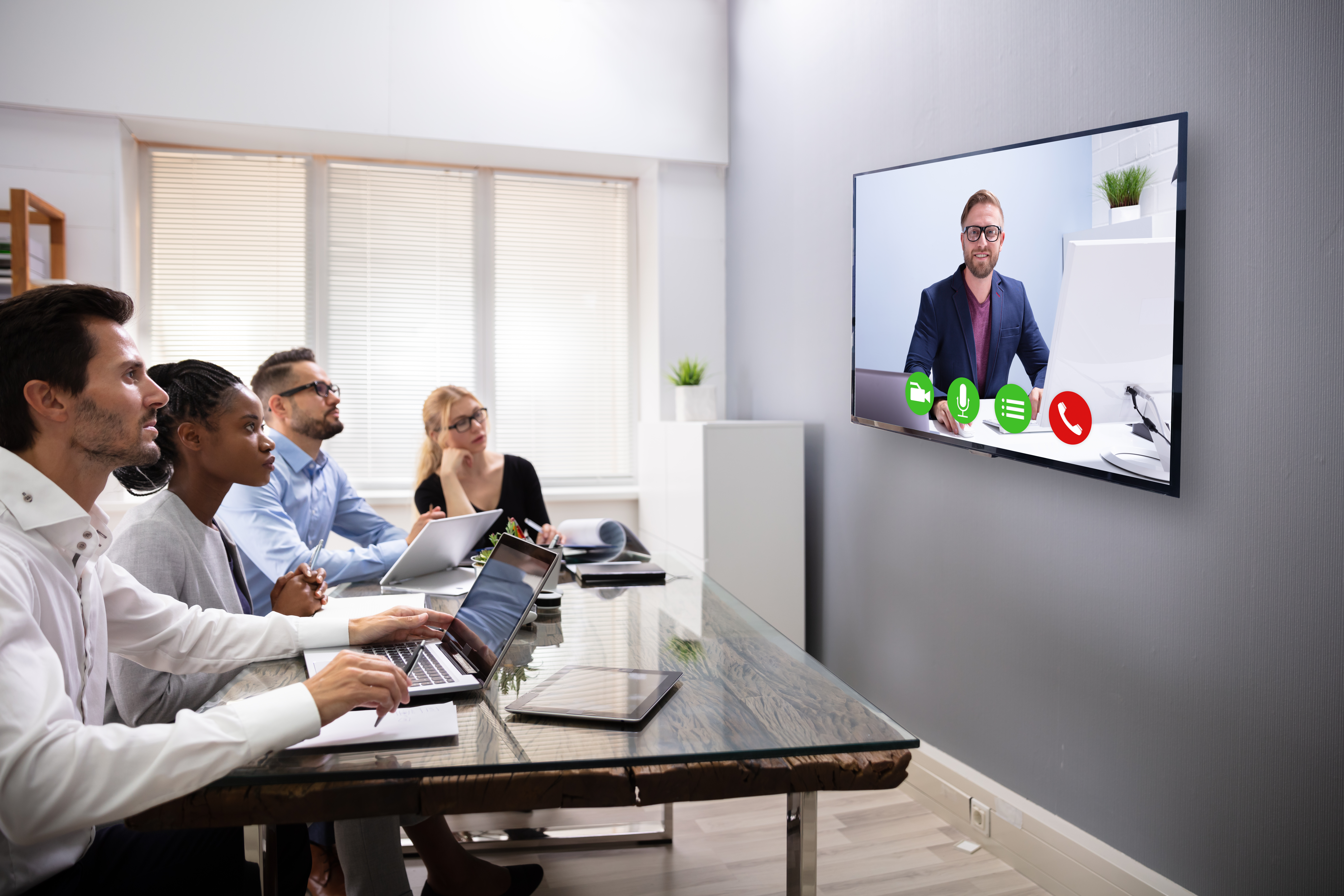 Businesspeople Sitting In A Conference Room Looking At Computer Screen
